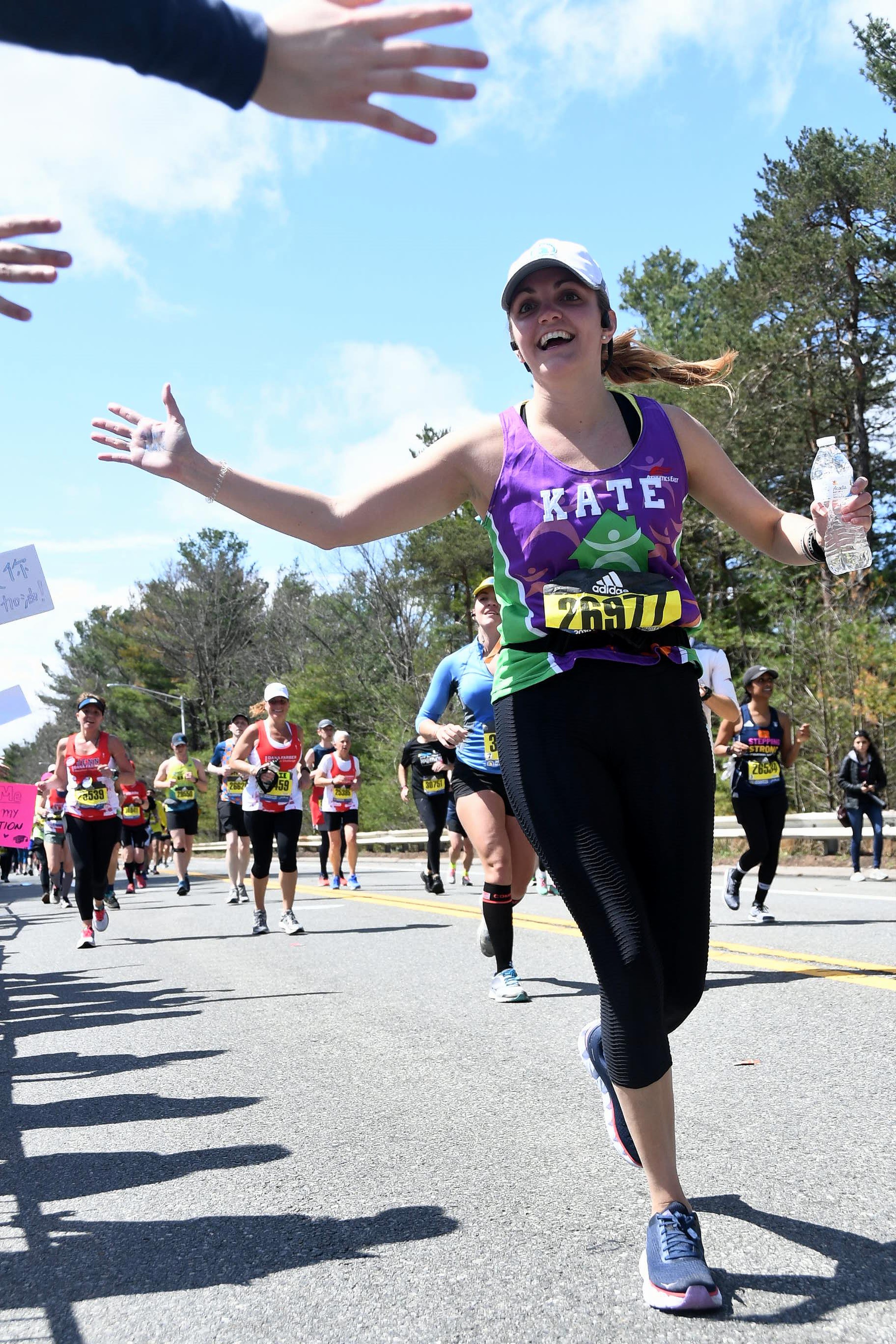A runner high-fiving the crowd